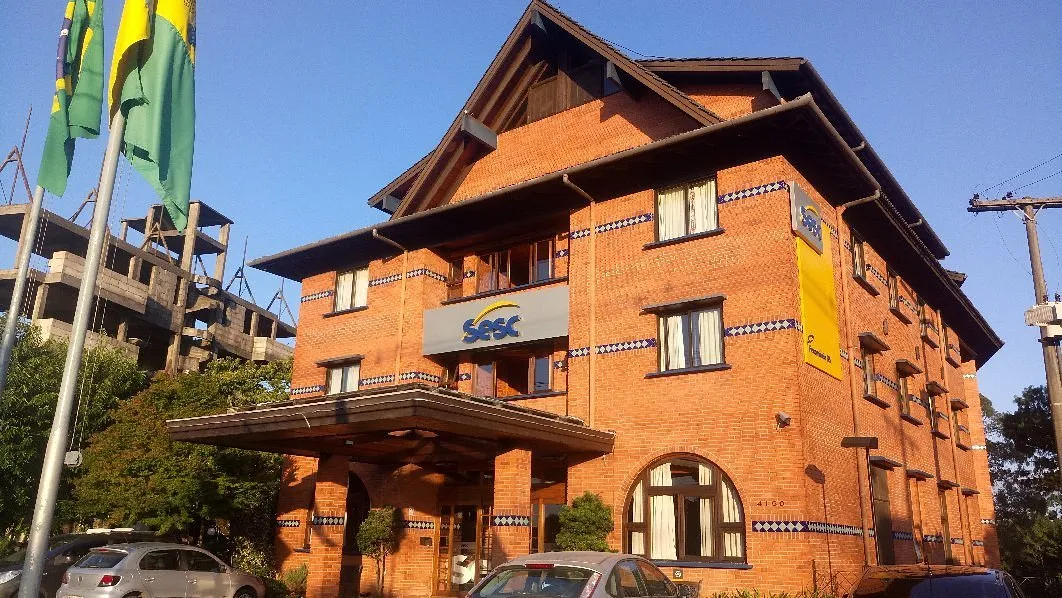 The Hotel Sesc Gramado building — brick and timber, with the Sesc sign above the entrance.